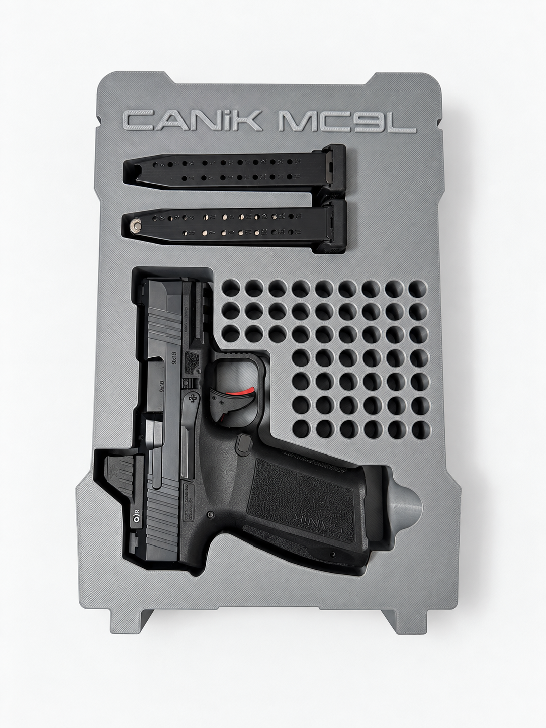 Retouched photograph of the real gray CANIK MC9L insert prototype used to develop the design, with a firearm and two magazines. Firearm and magazines are not included.